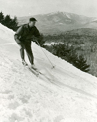 Sydney Mather skiing the Page Hill Slope, with Mt. Whiteface in the background